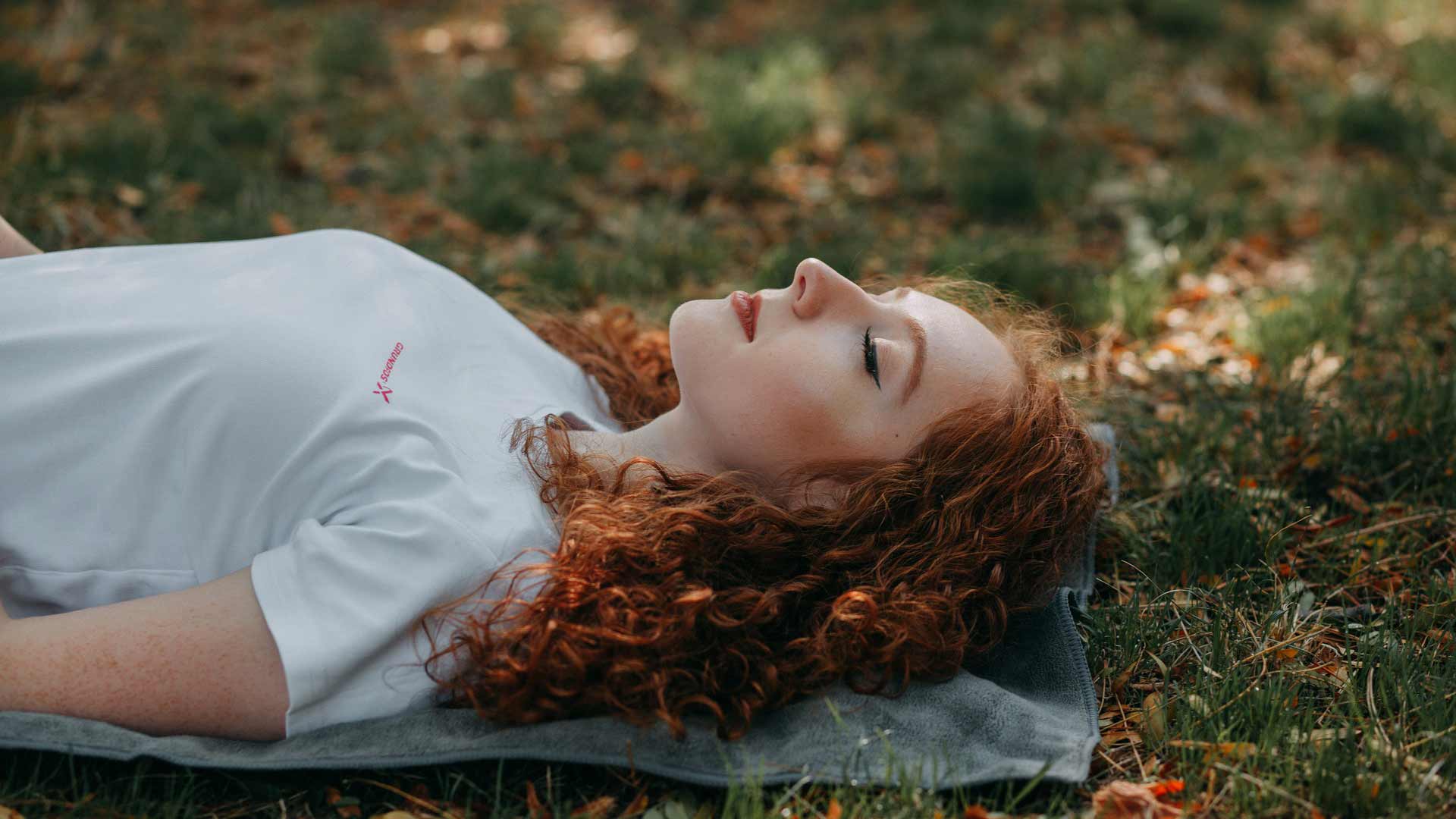 Young girl laying on the grass breathing